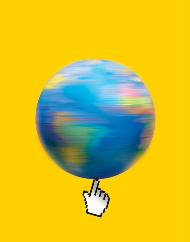 A digitally illustrated image of a spinning globe, blurred to indicate motion, set against a bright yellow background. At the bottom of the globe, a large pixelated computer mouse hand cursor appears to be spinning the Earth, emphasizing digital interaction with the world.