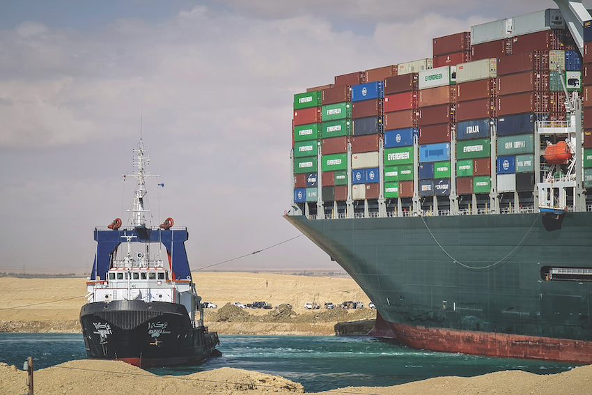 A ship and a tugboat in Suez canal