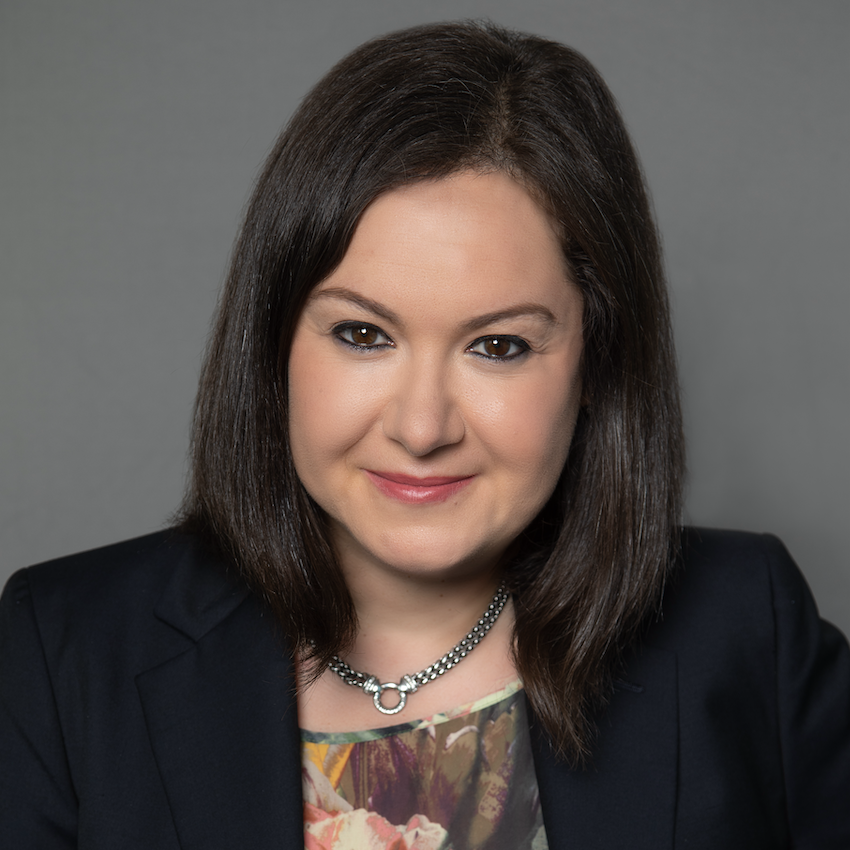 A headshot of Mary Rozenmann, CFO/CBO at insitro, a brunette woman wearing a black suit jacket
