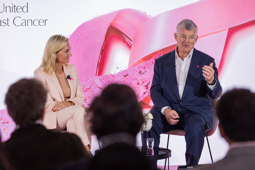 William P. Lauder speaks to employees at the company’s 
France-based Crystal Park office in front of a Breast Cancer pink ribbon backdrop.