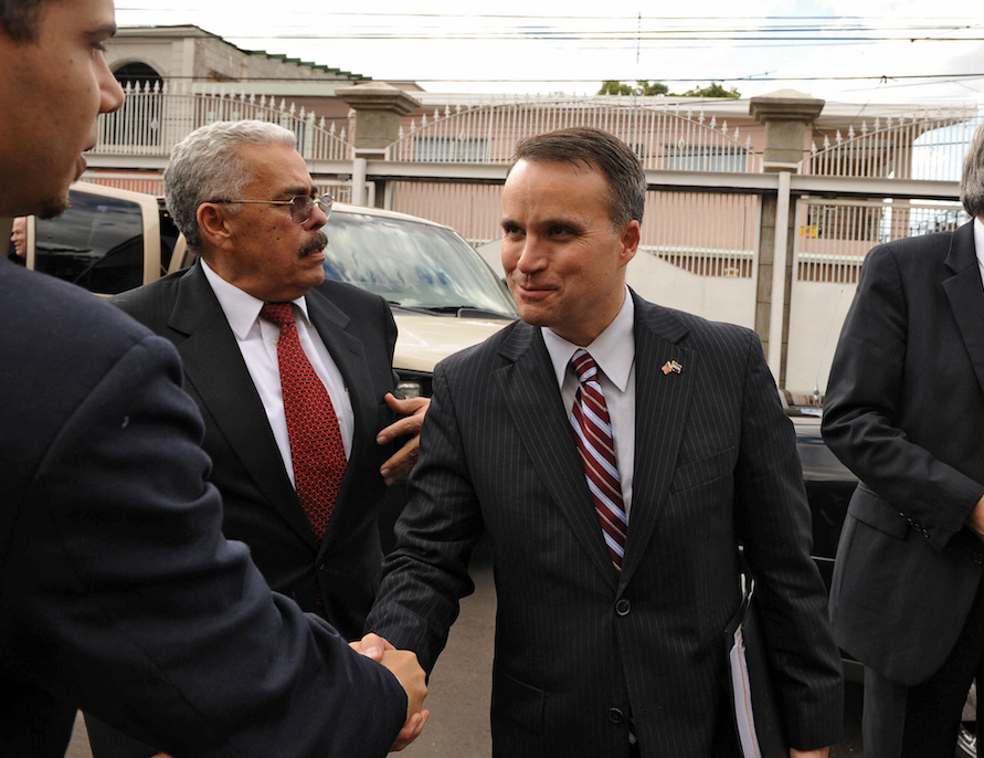 An image of Christopher Padilla, then-US Under Secretary of Commerce for International Trade, shaking hands with the Honduran government in a 2008 meeting about the Free Trade Agreement.