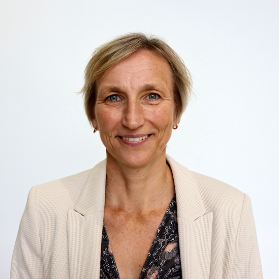 A headshot of Naomi Allen, Chief Scient at UK Biobank, a woman with a blonde pixie cut in a khaki suit jacket.