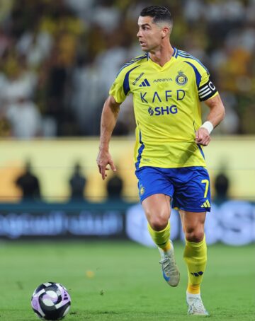 Cristiano Ronaldo of Al Nassr runs with the ball during the Saudi Pro League match between Al Nassr and Al Ittihad at Al-Awwal Park on May 07, 2025