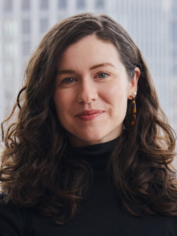 a headshot of a woman with curly brown hair