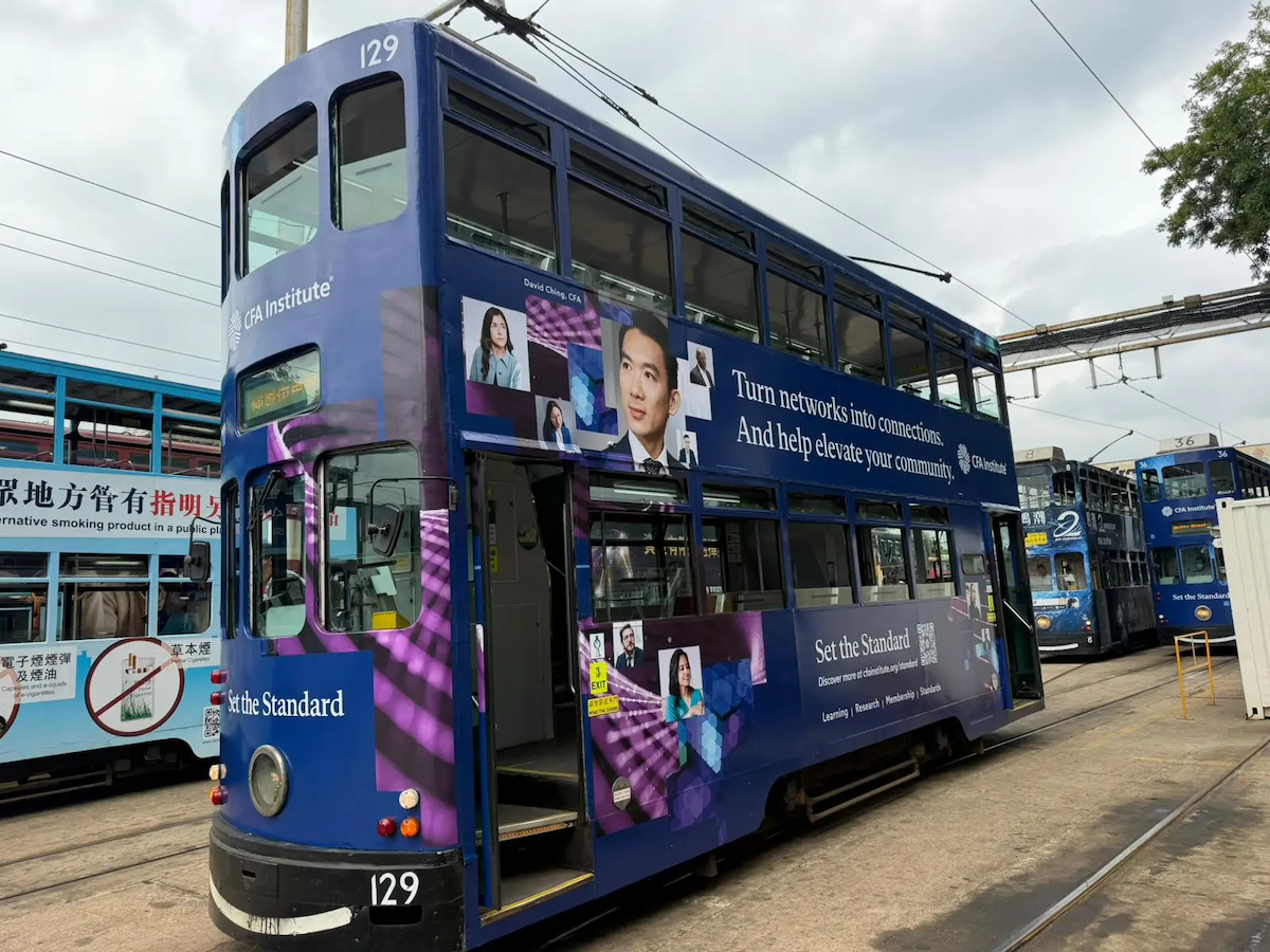 a photograph of a double decker blue bus with branding for CFA Institute.