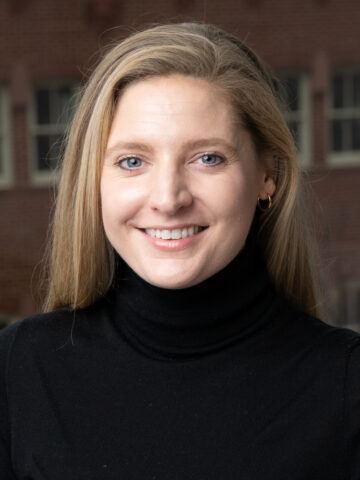 headshot of a blonde woman in a black turtleneck