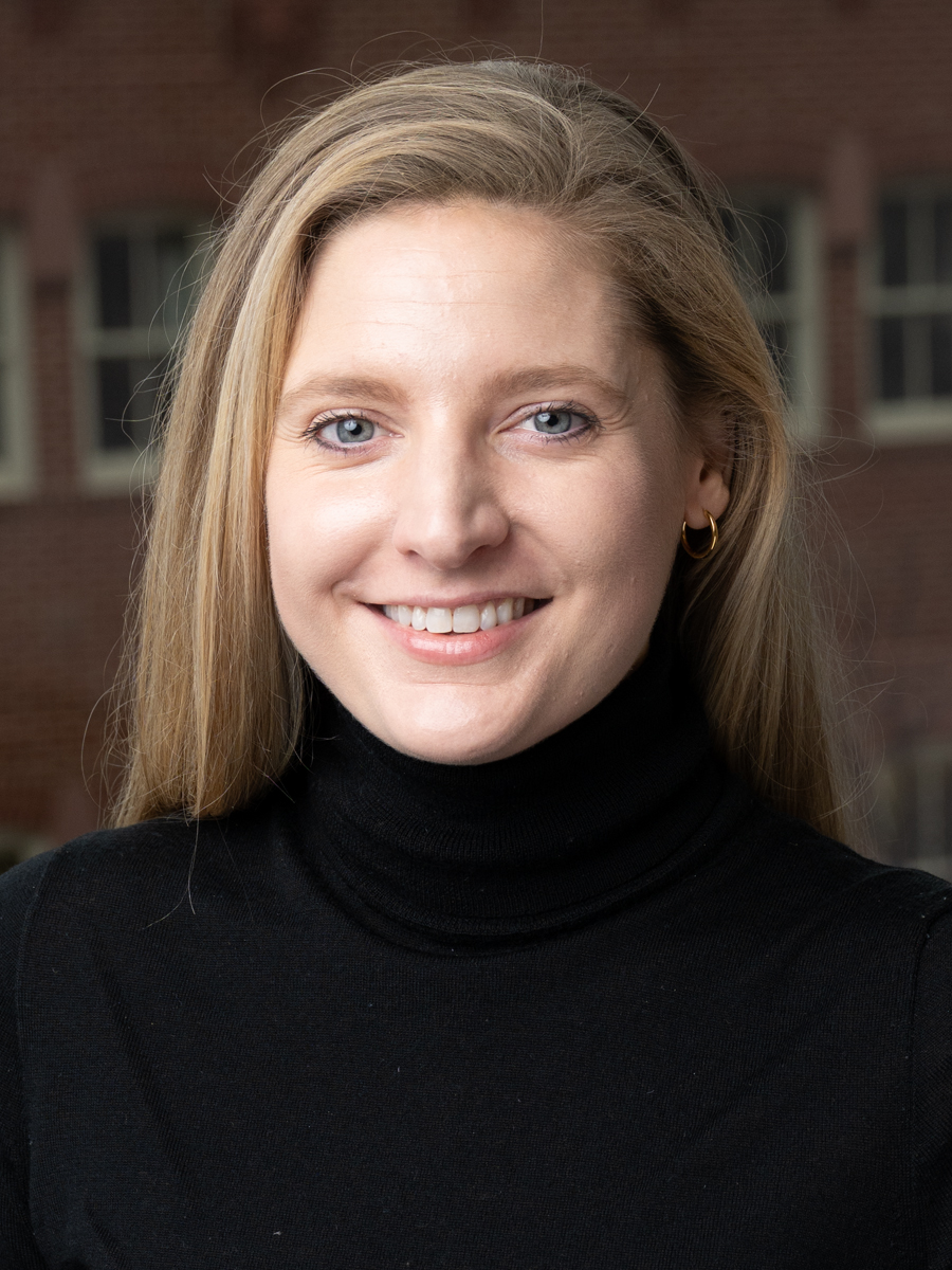 headshot of a blonde woman in a black turtleneck