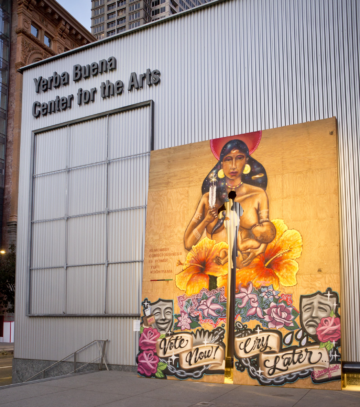 a photograph of the yerba buena center for the arts with a large canvas art piece propped up against it.